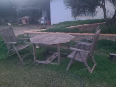 Terrace set, table and three wooden chairs.
