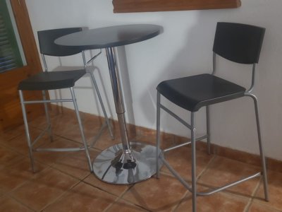 Two stools with small black metal table.